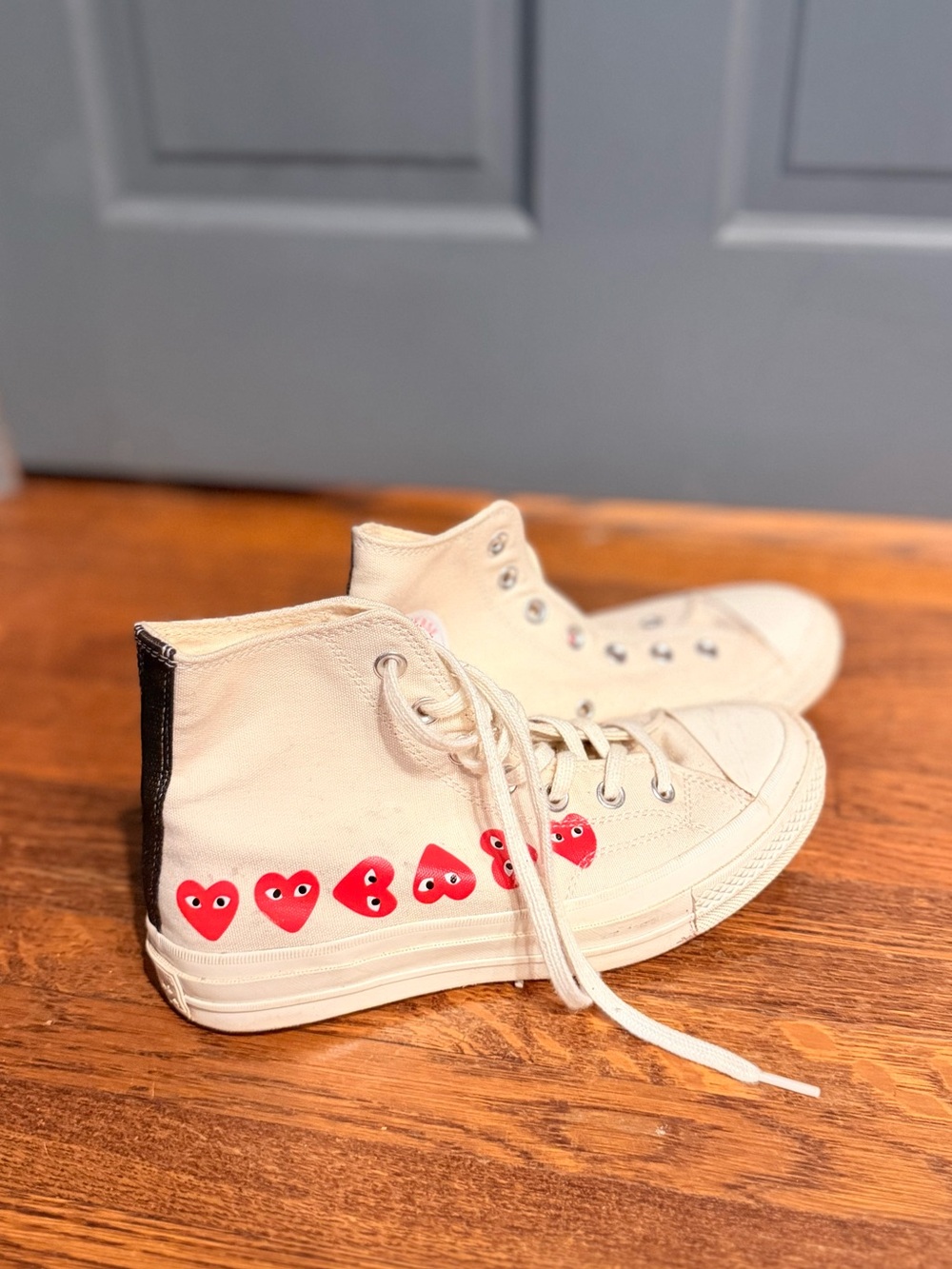 Comme des Garçons Play Cream High-Top Sneakers with Red Heart Motif